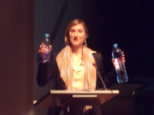 Cara Flowers holding up two bottles of water.