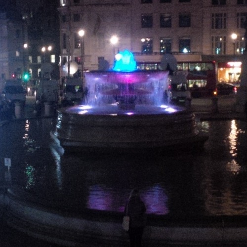 A fountain alternates red, white and blue.